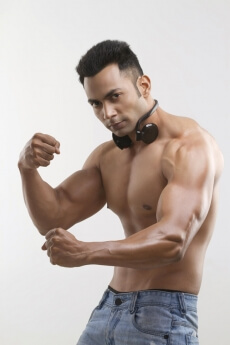 bare-chested male posing with headphones