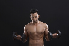 portrait of muscular man against a blue background