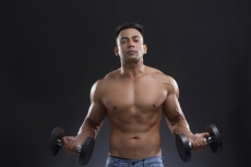 portrait of muscular man against a blue background