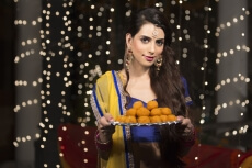 woman with a plate of ladoos