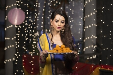 woman with a plate of ladoos