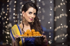 woman with a plate of ladoos