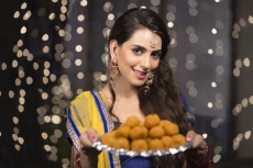 woman with a plate of ladoos
