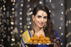 woman with a plate of ladoos