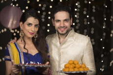 husband and wife with ladoo and thaali