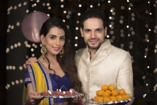 husband and wife with ladoo and thaali