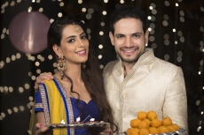 husband and wife with ladoo and thaali
