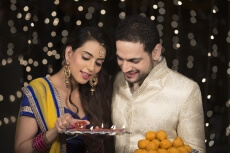 husband and wife with ladoo and thaali