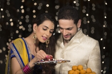 husband and wife with ladoo and thaali