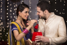 husband giving surprise to wife