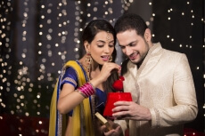husband giving surprise to wife