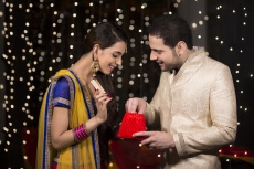 woman giving surprise gift to her husband 
