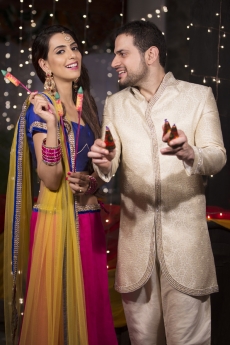 couple with crackers on diwali 