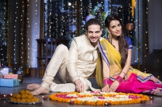 couple sitting and making rangoli on diwali