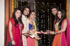 couples standing at entrance gate on diwali and welcoming you
