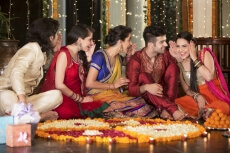 couple decorating home with rangoli and having fun