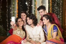 group of friends clicking photographs on a festival