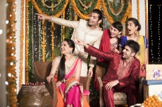 couples at diwali party pointing towards something