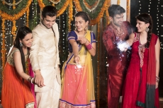 couple celebrating diwali with sparklers 