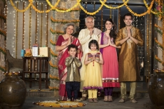 family standing at entrance gate to welcome