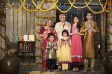 family standing at entrance gate to welcome