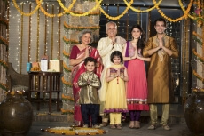family standing at entrance gate to welcome