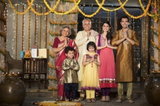 family standing at entrance gate to welcome