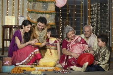 family celebrating diwali and doing pooja