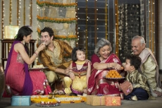 family celebrating diwali and doing pooja