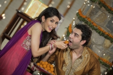 wife feeding ladoo to husband on diwali