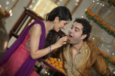 wife feeding ladoo to husband on diwali