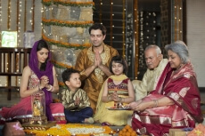 whole family sitting for diwali pooja