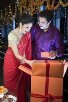 couple opening presents on a festival