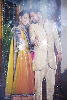 couple playing with sparklers on diwali 