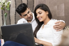 couple on couch with laptop