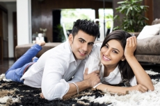 couple lying on floor and smiling for the camera 