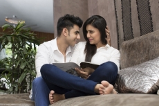couple on couch looking at each other