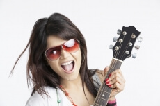 close-up of a girl playing guitar