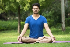 boy performing yoga in park during morning time