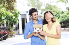 man surprising woman with new home
