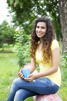 girl in the park having coffee