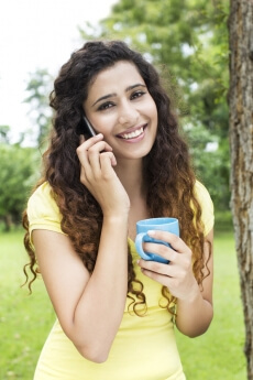 girl attending call while having coffee