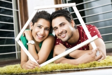 couple lying on rugs holding frame