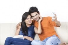 couple taking picture with mobile phone