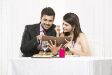 couple on romantic dinner date looking at the menu