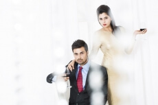 stylish couple posing with red wine