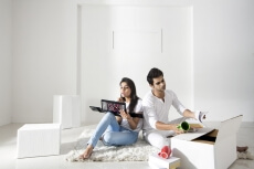 husband unpacking while wife applying make-up