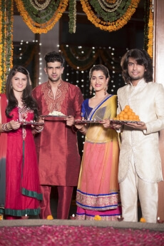 couple in traditional wear standing with thalis