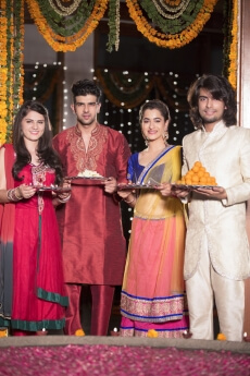 couple in traditional wear standing with thalis