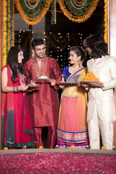 couple in traditional wear standing with thalis